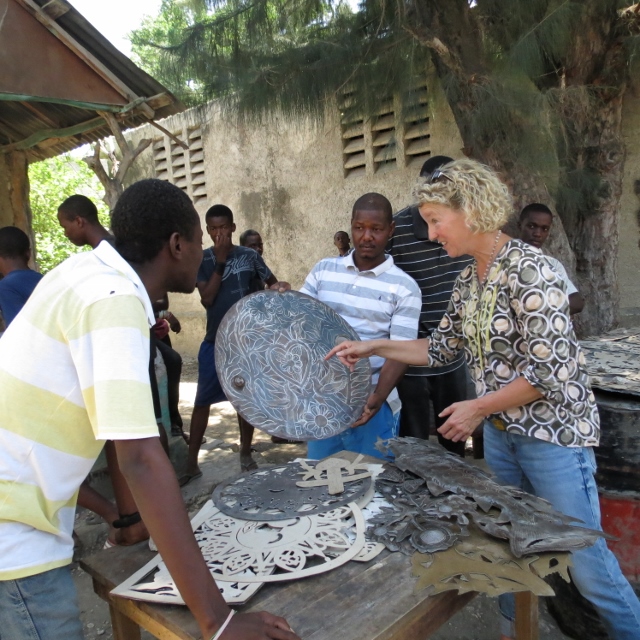 Casey in action! Working with her Haitian metal artists and practicing fair trade.