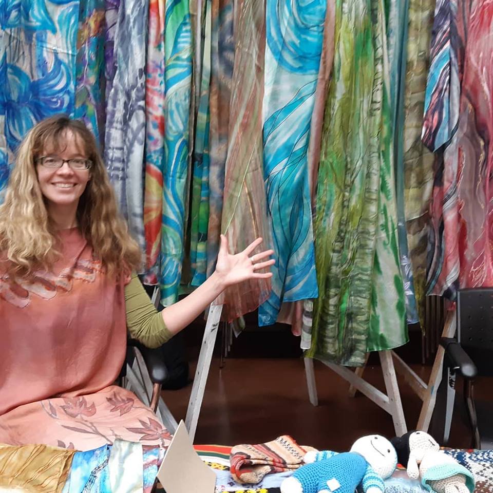 Maria of Singing Scarves selling her scarves at an art event.
